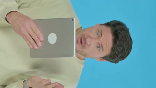 Man Interacting With Tablet Device, Blue Background