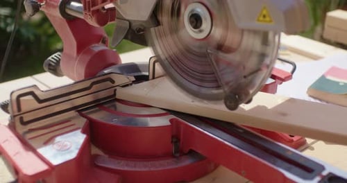 Close up of sawing a marked piece of wood to size