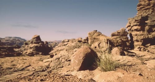 Rocky Landscape with Sparse Vegetation Under a Clear Sky in a Desert Setting
