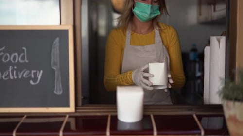 Woman Preparing Delivery Food Inside Takeaway Restaurant During Coronavirus Outbreak Period - Wor...