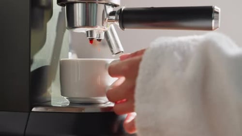 Espresso Drips into a White Ceramic Cup