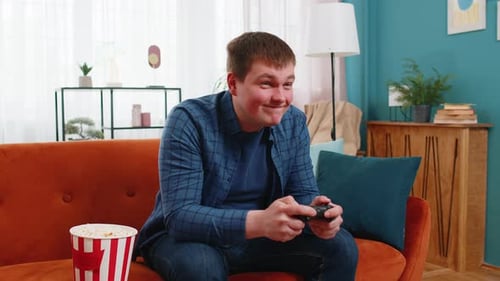 Man Playing Video Games on Living Room Couch
