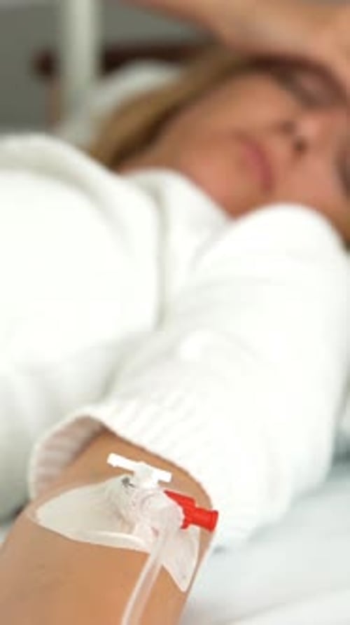 A Female Patient in a Hospital Ward with a Drip
