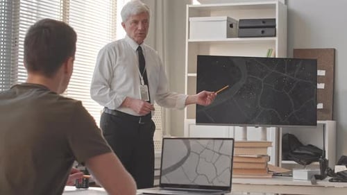 Instructor at Military Academy Giving Lesson to Young Recruit