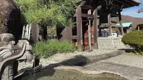 Temizuya dragon fountain basin at Buddhist temple in mtns of Japan