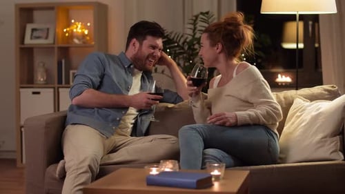 Couple Relaxing with Red Wine at Home