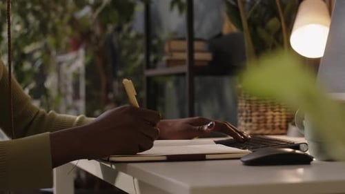 Unrecognizable Black Female Programmer Coding in Green Office