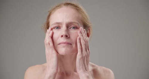 Woman Gently Massaging Face for Skincare Routine