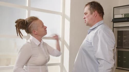 Conflict disagreement between businessman and businesswoman or employees at work in office