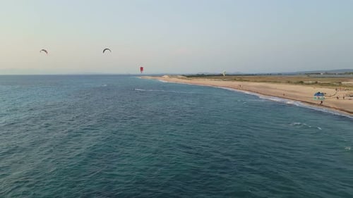 Kitesurfers Enjoying a Windy Day on a Sandy Beach – Aerial View