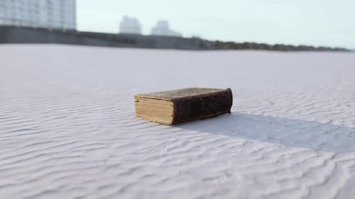 Old Book on the Sand Beach