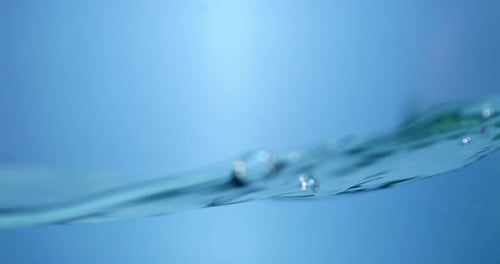Raindrop Falling into a Pool of Water. Smooth Circular Ripples on a Calm Surface.