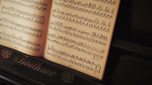Notes chart on an old Blüthner grand piano, slow tripod tilt up shot.