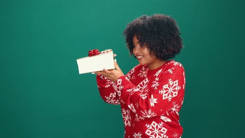 Peeking, gift and woman with giveaway, studio or excited for festive season, smile and mockup space