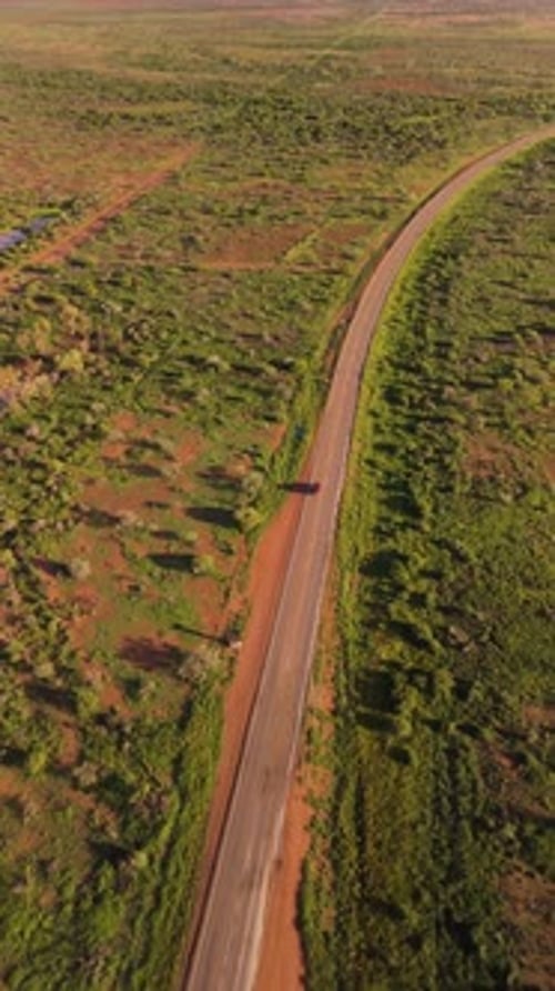 Aerial view of winding road through arid landscape, Australia.