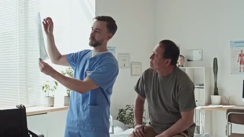 Doctor Showing X-ray Image to Patient