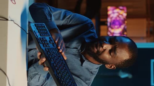 Focused Man Working Online with Keyboard and Headphones