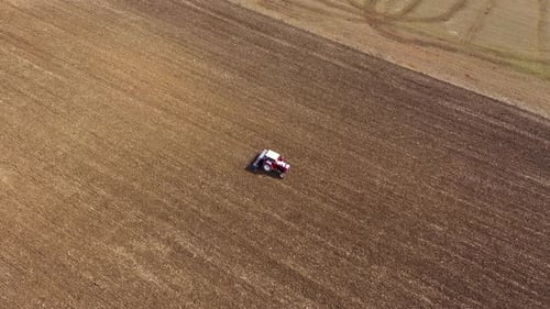 Spring Agricultural Field Work, Tractor With Seeder Sow Seeds in Ground Aerial Slow Motion