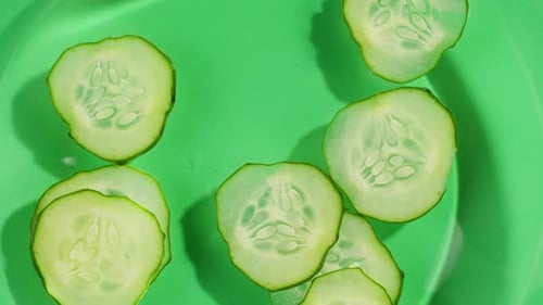 Close up of Fresh Cucumber Slices on Green