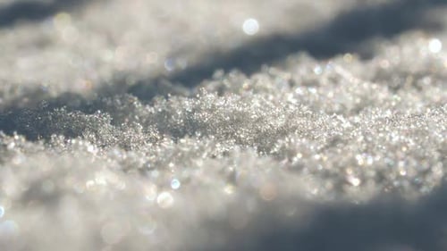 Nahaufnahme der Schneeoberfläche Schneekristalle in verschiedenen Größen sind sichtbar und zeigen die Textur