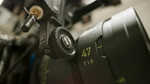Low angle close-up of a focus motor on a professional cinema camera calibrating, turning the focus r