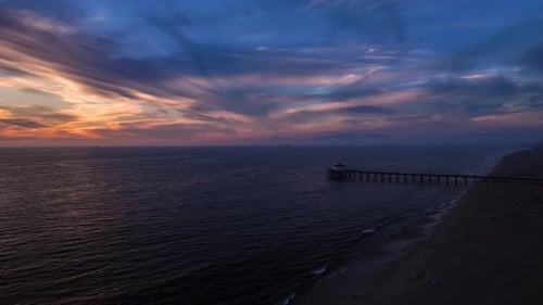 Aerial view of sunset over ocean and pier, United States.