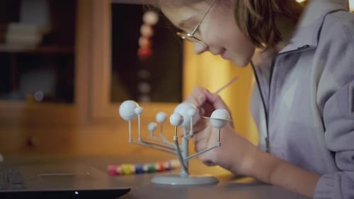 Child Paints a Model Solar System at Home