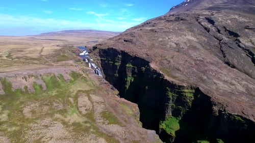 Glymur Waterfall Cascading Down Icelandic Highland Gorge -aerial drone shot