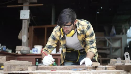 Carpenter make furniture at workshop.