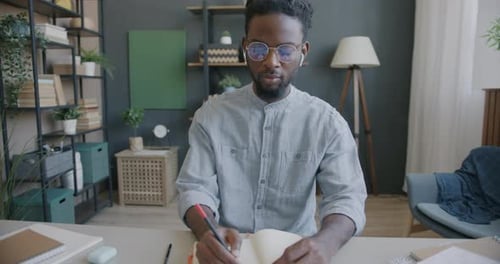 Portrait of Online School Teacher Speaking Gesturing and Writing During Video Call with Student