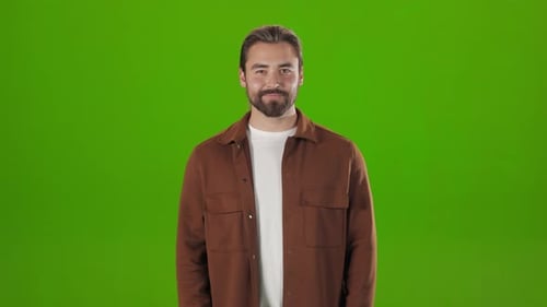 Caucasian Man Standing in Studio and Winking on Camera