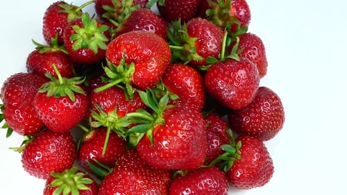 Pile of Fresh Red Strawberries on White Surface