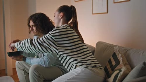 Couple Eating Together on Couch at Home