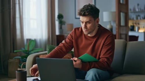 Guy Watching Online Course at Laptop Sitting Couch Man Drinking Coffee Studying