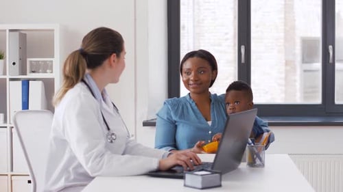 Doctor and Mother with Infant at Checkup