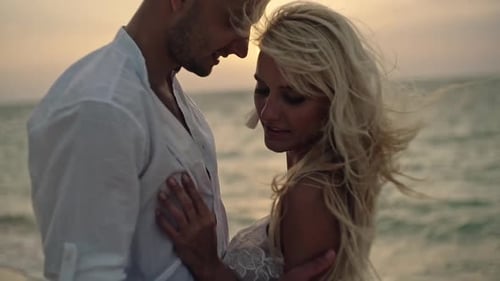 Sensual Loving Couple on the Beach at Sunset