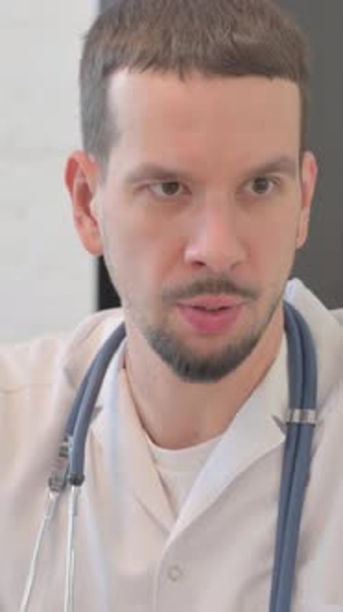 Close up of Doctor Talking with Mixed Race Man in Clinic, vertical video