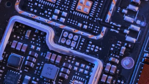 Microchips background in neon lilac blue. Circuit board surface extreme close up.