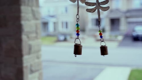 Wind Chime Swaying Gently on a Suburban Porch