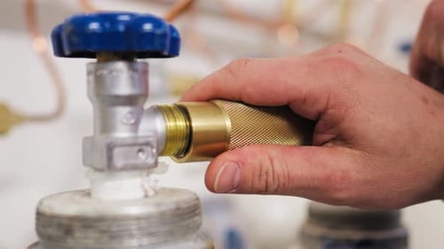 Brass Adapter Being Connected to Silver Valve