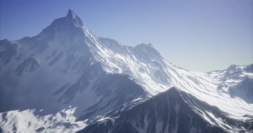 Majestic Snow Capped Mountain Range Under Clear Blue Sky in Daylight