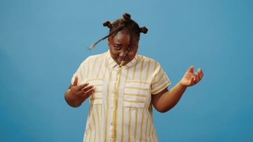 Energetic Female Playing on Imaginary Guitar in Studio