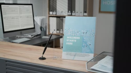 Wellness Flyer and Pen Stand on Desk at Hospital Reception Area