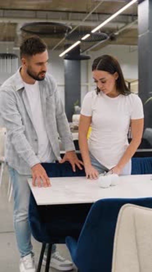 Just Married Couple Choosing Dining Table Furniture in Showroom