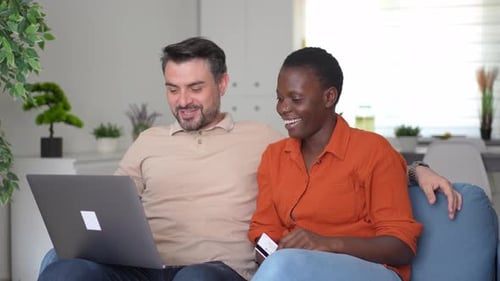 Happy Couple Shopping Online at Home with Laptop