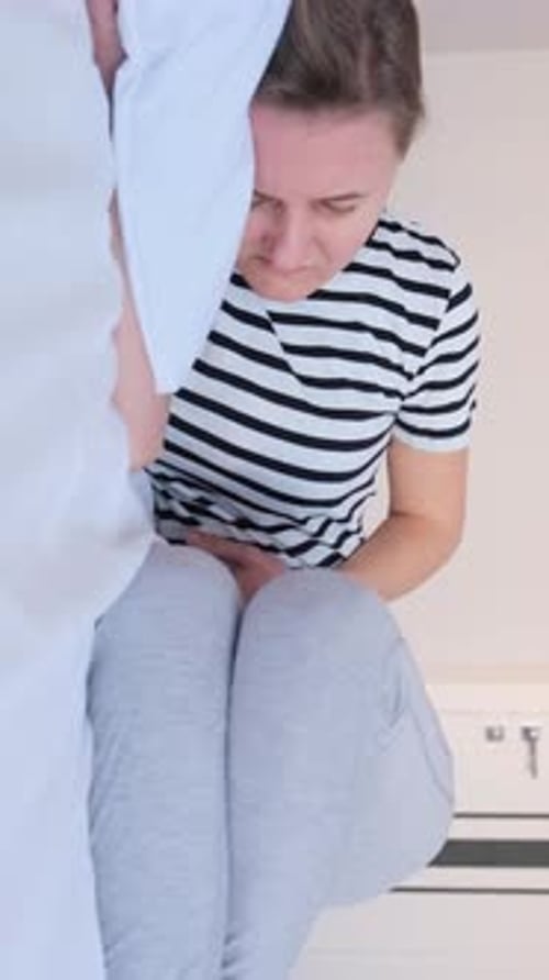 Suffering Sick Woman Lies on the Bed and Holds Her Stomach Vertical Video