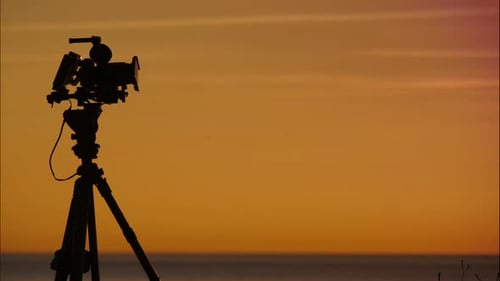 Camera Silhouette on Beach During Golden Hour