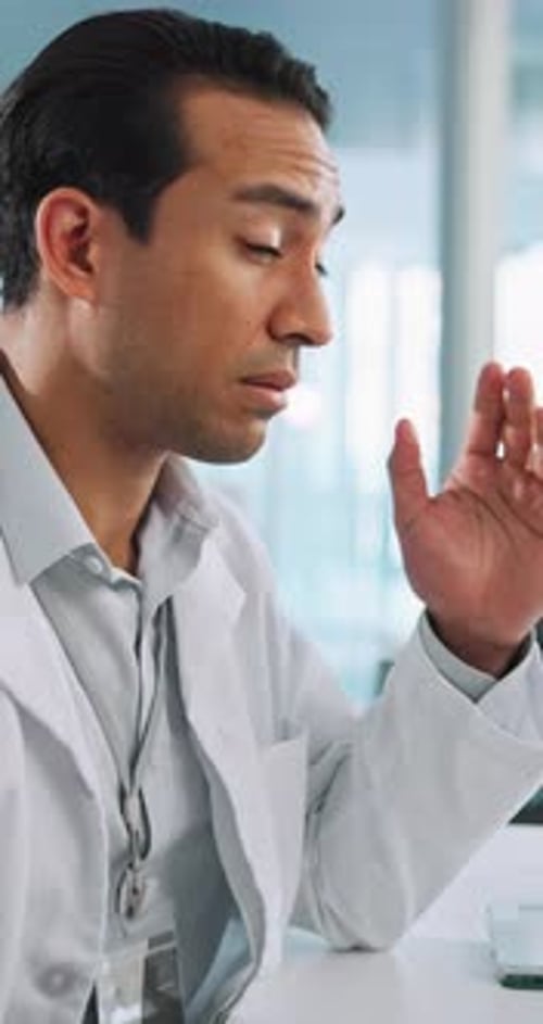 Stressed Doctor Rubbing Temple in Modern Office