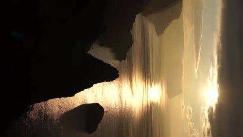 Colorful Warm Sunrise or Sunset Over the Sea and Volcanic Basalt Rocks Like in Iceland