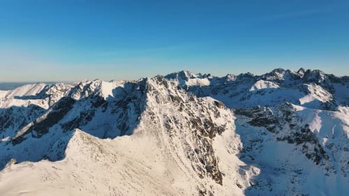 Breathtaking aerial views of the snow-covered Alps during a clear day